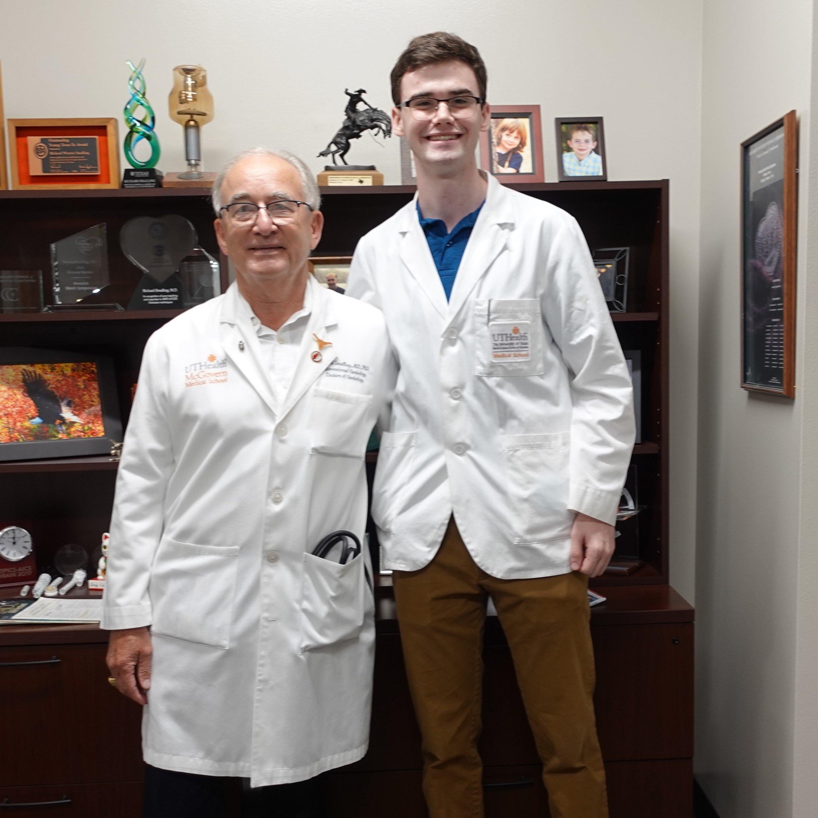 One of the four selected for the Mary Ann Lunsford Student Summer Externship, Carson Benner, 22, (right) learned more about cardiovascular medicine from Richard W. Smalling, MD, PhD, (left) professor with UTHealth Houston. (Photo by UTHealth Houston)