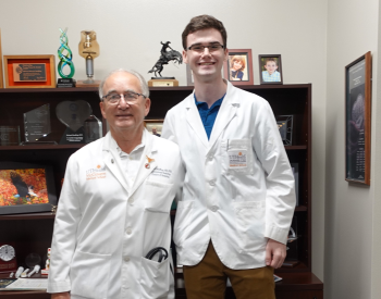 One of the four selected for the Mary Ann Lunsford Student Summer Externship, Carson Benner, 22, (right) learned more about cardiovascular medicine from Richard W. Smalling, MD, PhD, (left) professor with UTHealth Houston. (Photo by UTHealth Houston)