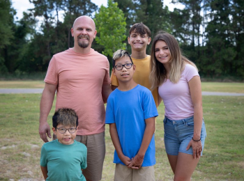 Cayman Westerkamp (front, middle) poses with his family. From left to right: his brother, Beau; father, Jason; brother, Gavin; and sister, Hallie. (Photo by Alyssa Duty, UT Physicians)