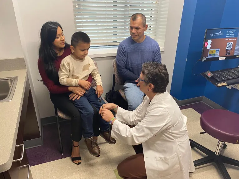 Dylan Mendoza, 6, pictured with his parents, Maria Perez and Ruben Mendoza, is observed by Gretchen Von Allmen, MD during his appointment at the SCN2A Multidisciplinary Center at UTHealth Houston. (Photo by Caitie Barkley/UTHealth Houston)