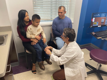 Dylan Mendoza, 6, pictured with his parents, Maria Perez and Ruben Mendoza, is observed by Gretchen Von Allmen, MD during his appointment at the SCN2A Multidisciplinary Center at UTHealth Houston. (Photo by Caitie Barkley/UTHealth Houston)