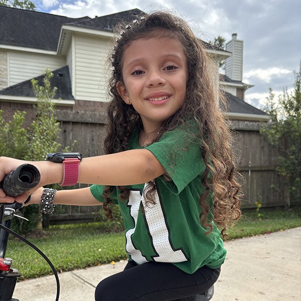 Alison Casey, 6, rides a bike shortly after undergoing hip surgery. (Photo provided by Shelly Casey)