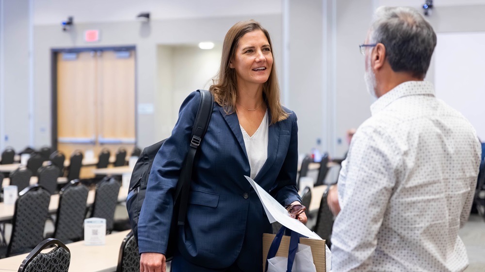 Female student having a conversation with a male faculty member