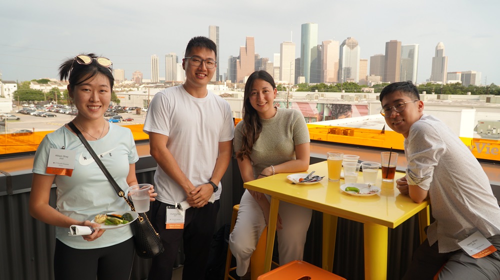 Four School of Public Health alumni posing for a photo at an event