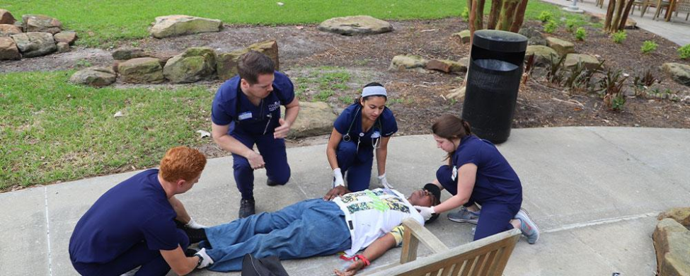 A group of UTHealth Houston students treat wounds of a mock 