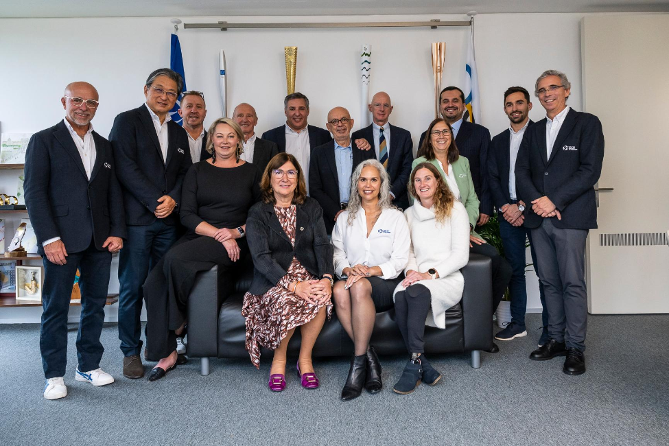 Gabriela Gallegos, JD, MPP (seated center) attends the opening of the World Triathlon office in Lausanne, Switzerland. Photo courtesy of World Triathlon Media.