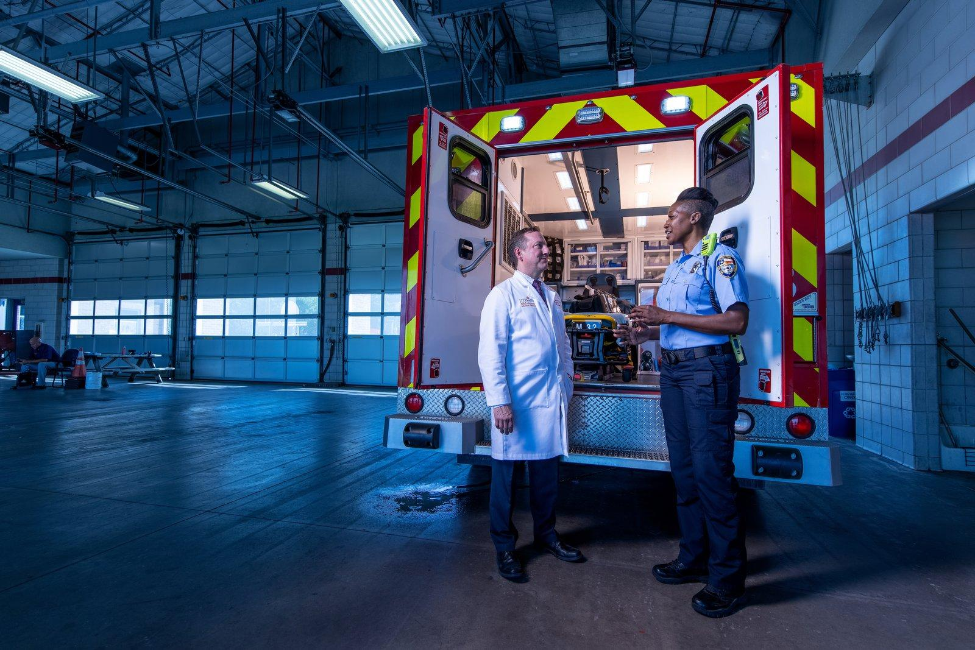 James R. Langabeer II, PhD, EdD, and Ashley Mackie of HEROES in front of ambulance