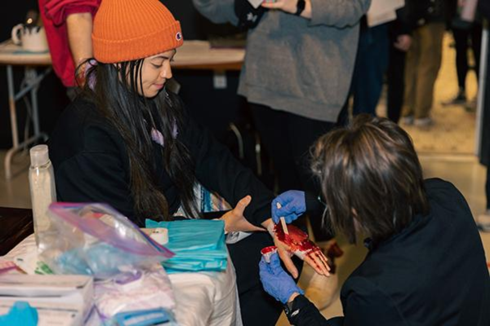 One student, assigned as a victim, gets a moulage makeover ahead of the staged mass casualty incident. (Photo by Rogelio Castro/UTHealth Houston)