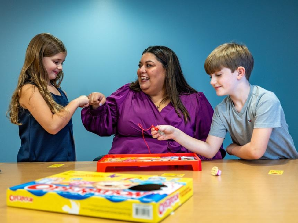 Vilma Sofia “Sofi” Caballero interacting with 2 children