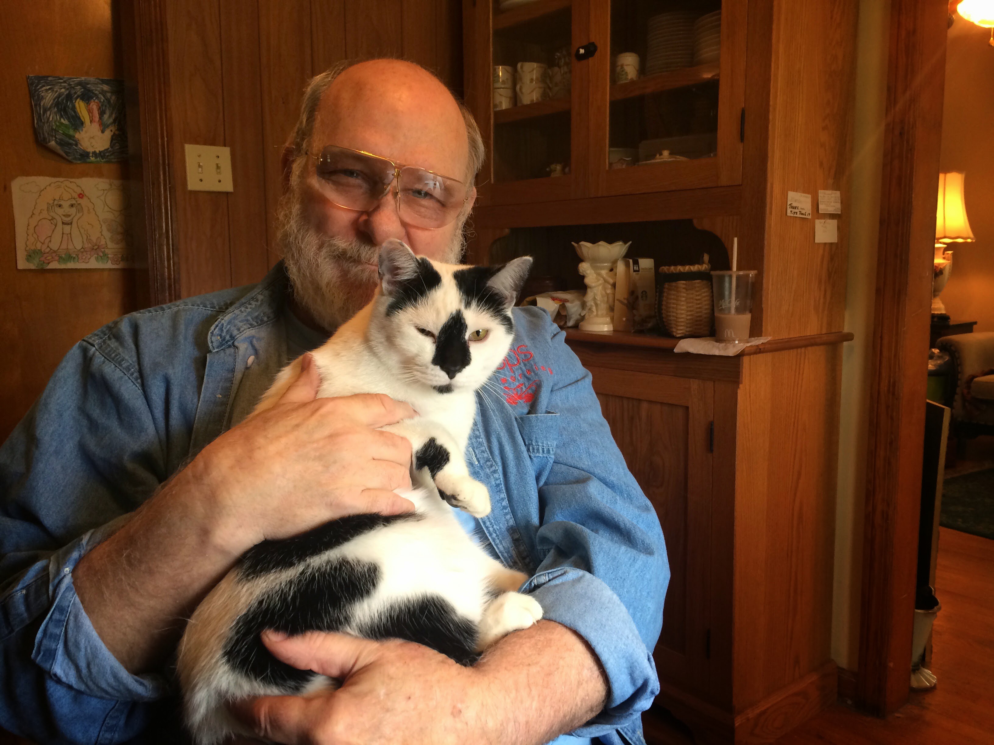 Myron Loop holding his cat (pepper)