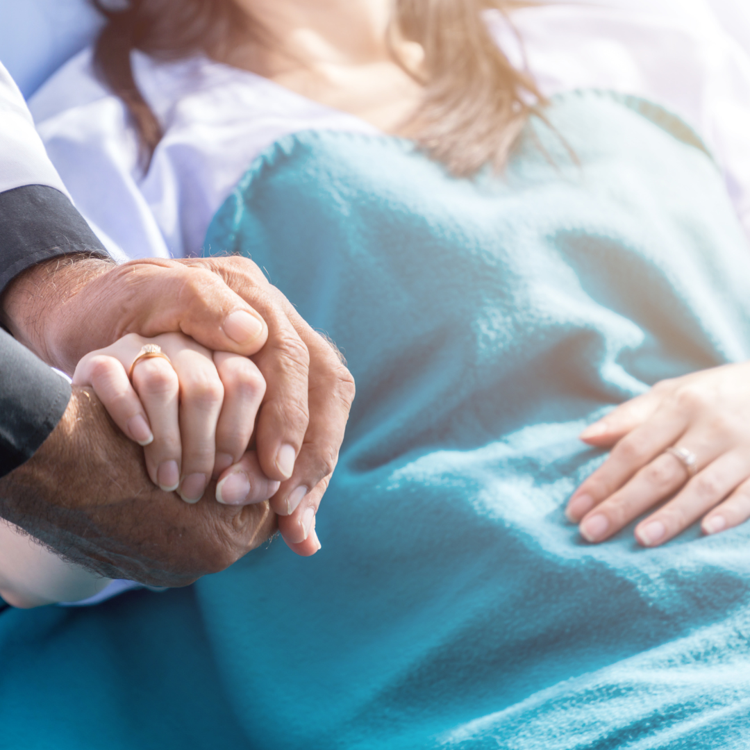 Patient in the hospital in pain, being comforted by a doctor