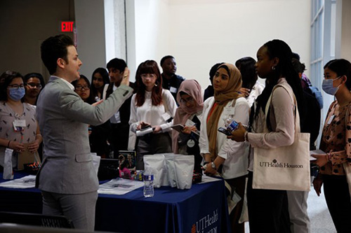 UTHealth Houston Pathways Healthcare Conference image with speaker engaging a variety of UTHealth Houston Students and Employees